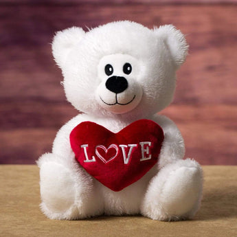 A white bear holding a red love heart