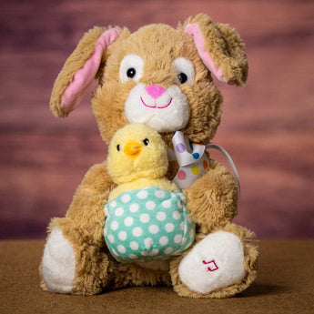 A animated/singing brown rabbit that is 11 inches tall while sitting holding a baby chick in a basket