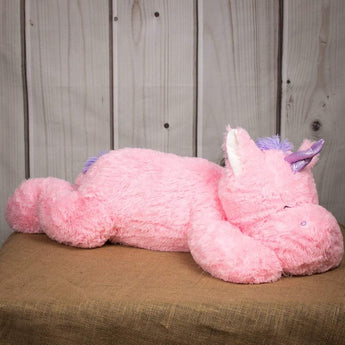 A laying pink unicorn that is 40 inches from head to tail