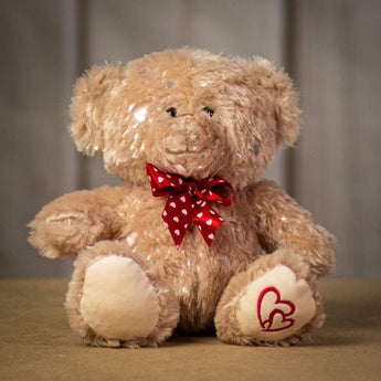 A sitting beige bear with glittering fur