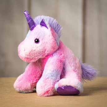 A sitting pink unicorn with a matching purple horn