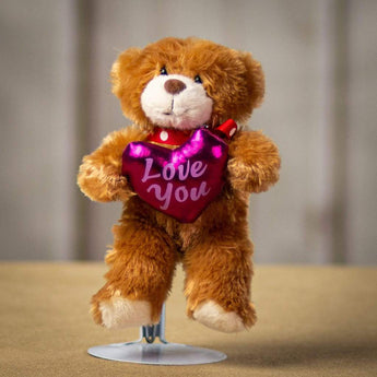 A brown bear holding a shiny Love You heart