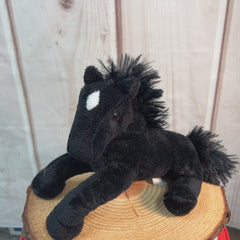 A black horse that is 9 inches from head to tail