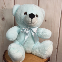 A light blue bear that's 9 inches tall while sitting