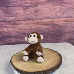 A brown monkey that is 5 inches tall while sitting