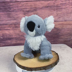 A white and gray koala that is 10 inches tall while sitting