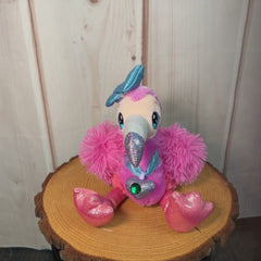 360 degree video of a 8" glamorous pink flamingo with sparkly legs, a diamond necklace, and a sparkly blue bow