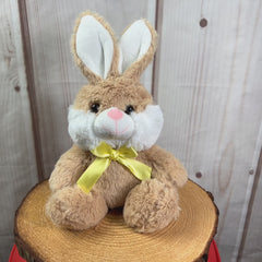 A beige rabbit that is 10 inches while sitting wearing a yellow bow