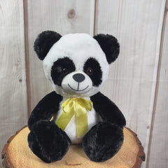 A black and white panda that is 10 inches tall while sitting wearing a yellow bow