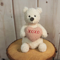 10" stuffed bear that is holding a stuffed heart that says, "xoxo".