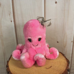 8 inch Pink octopus with eyelashes and wearing a bow