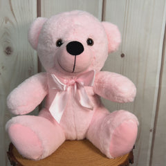 A light pink bear that's 9 inches tall while sitting