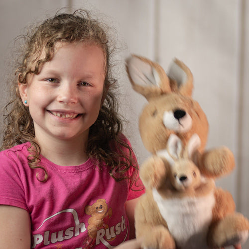 girl holding 10" tan Kangaroo with a pocket for theJoey