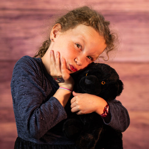 girl holding 10 in stuffed black panther