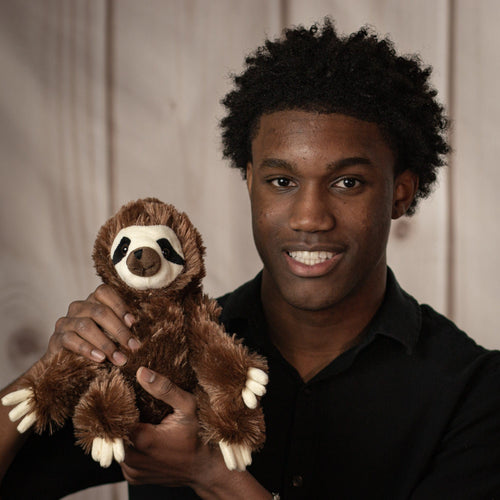 Young man holding a stuffed sloth