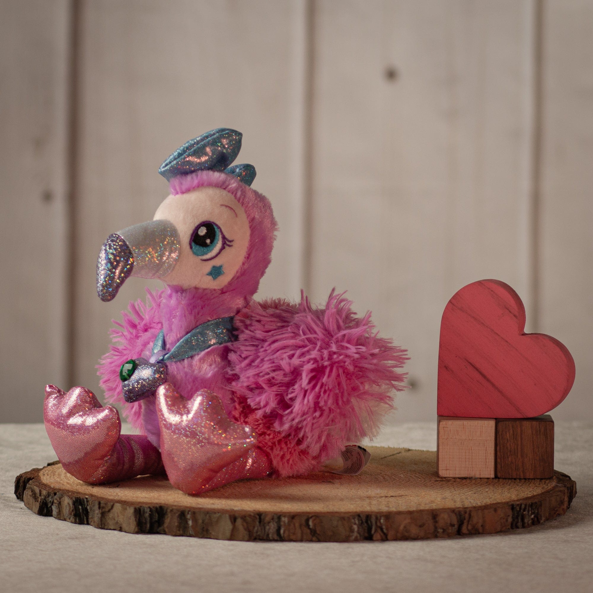 8" glamorous pink flamingo with sparkly legs, a diamond necklace, and a sparkly blue bow