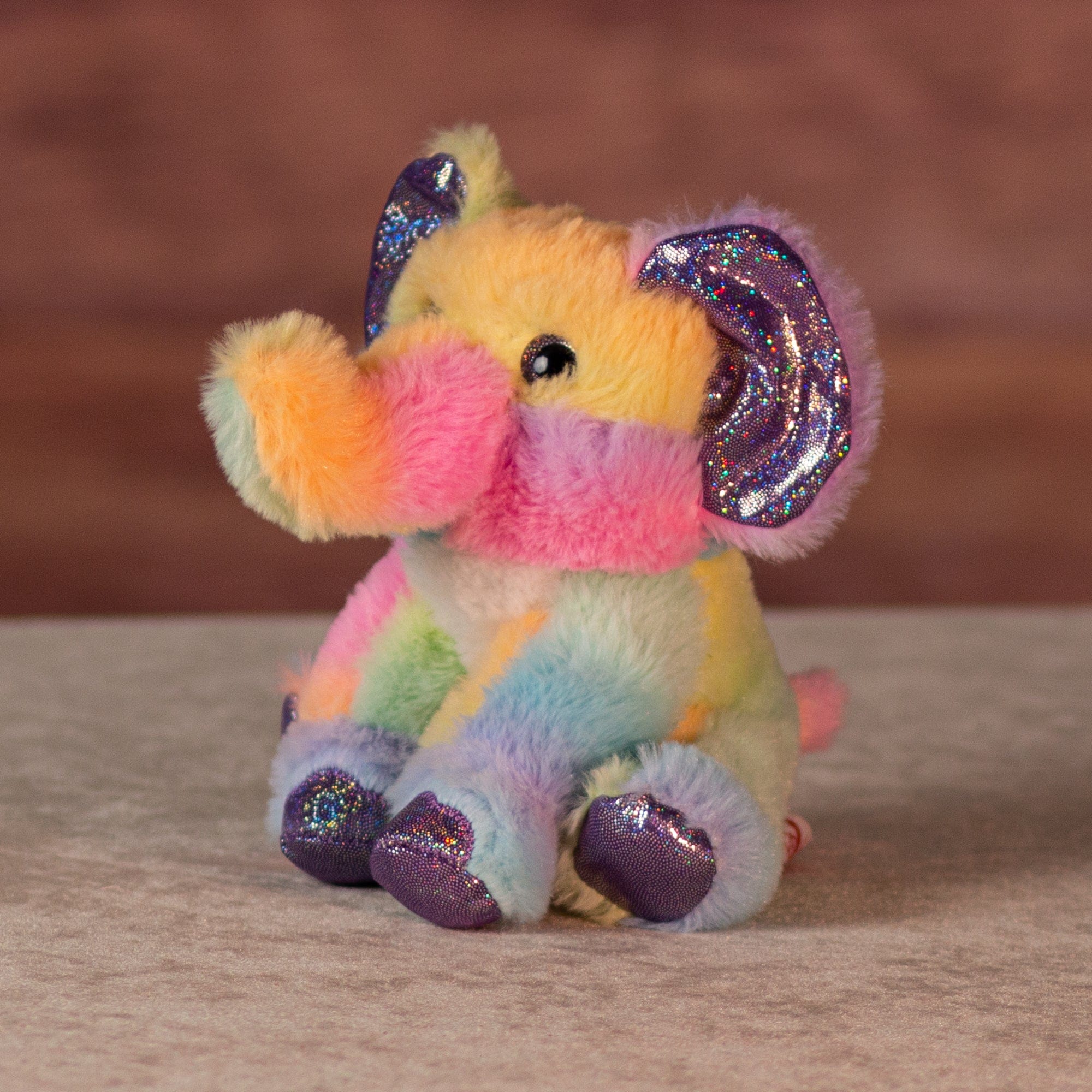 6 in rainbow sherbet elephant with purple glitter hands and feet