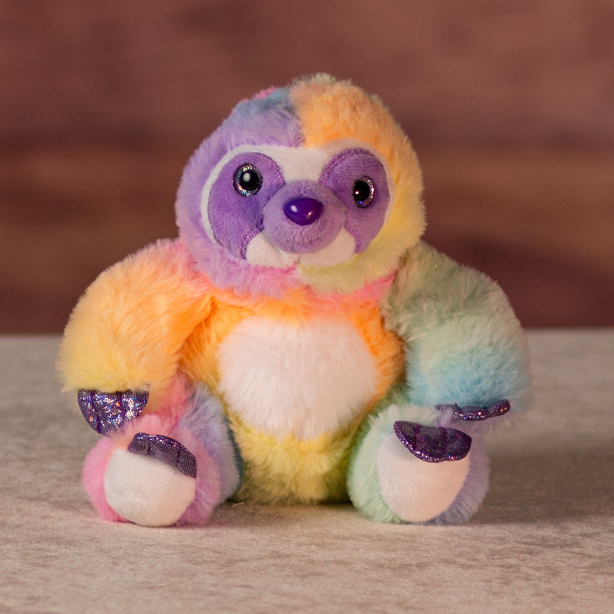 6 in rainbow sherbet slothwith purple glitter hands and feet