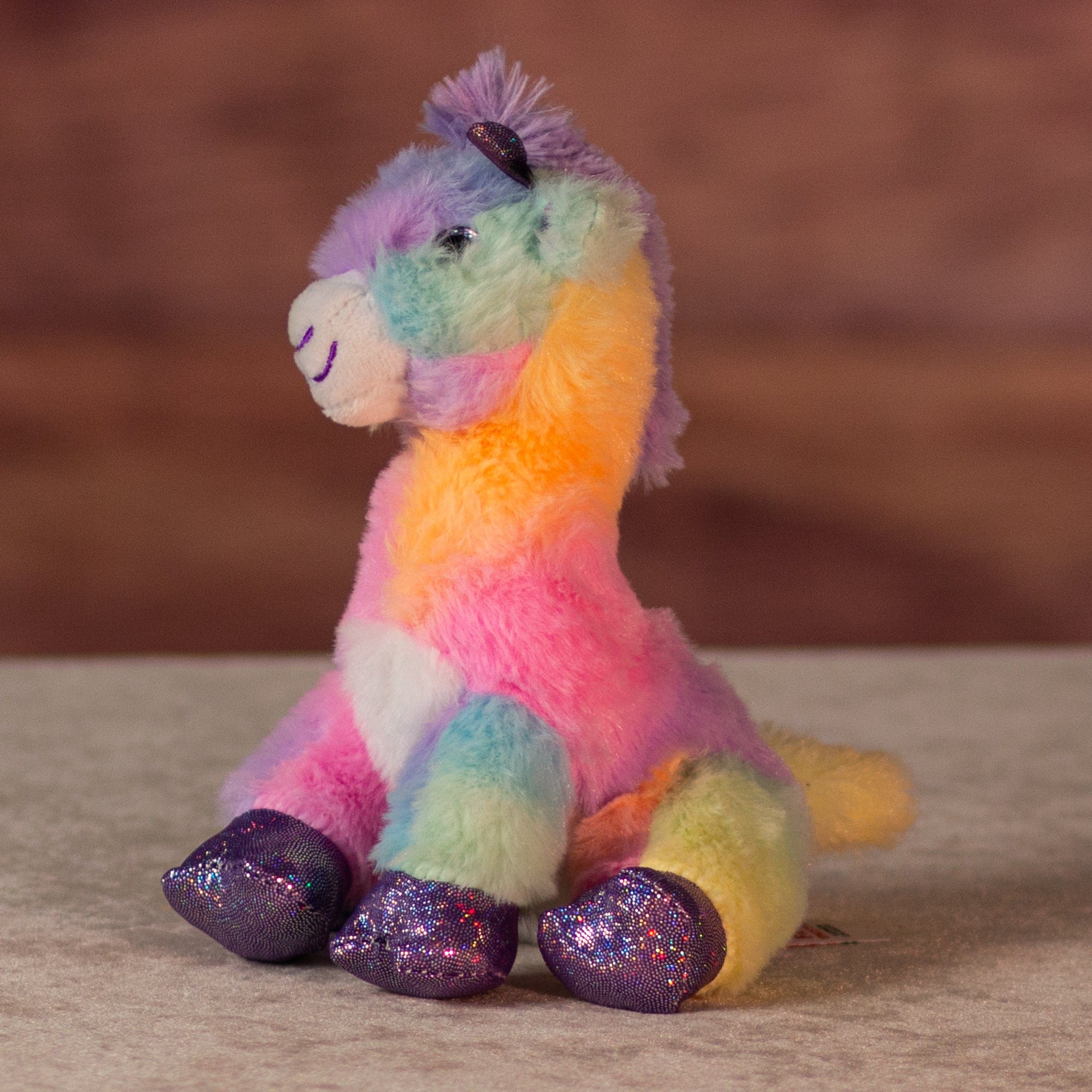 6 in rainbow sherbet giraffe with purple glitter hands and feet