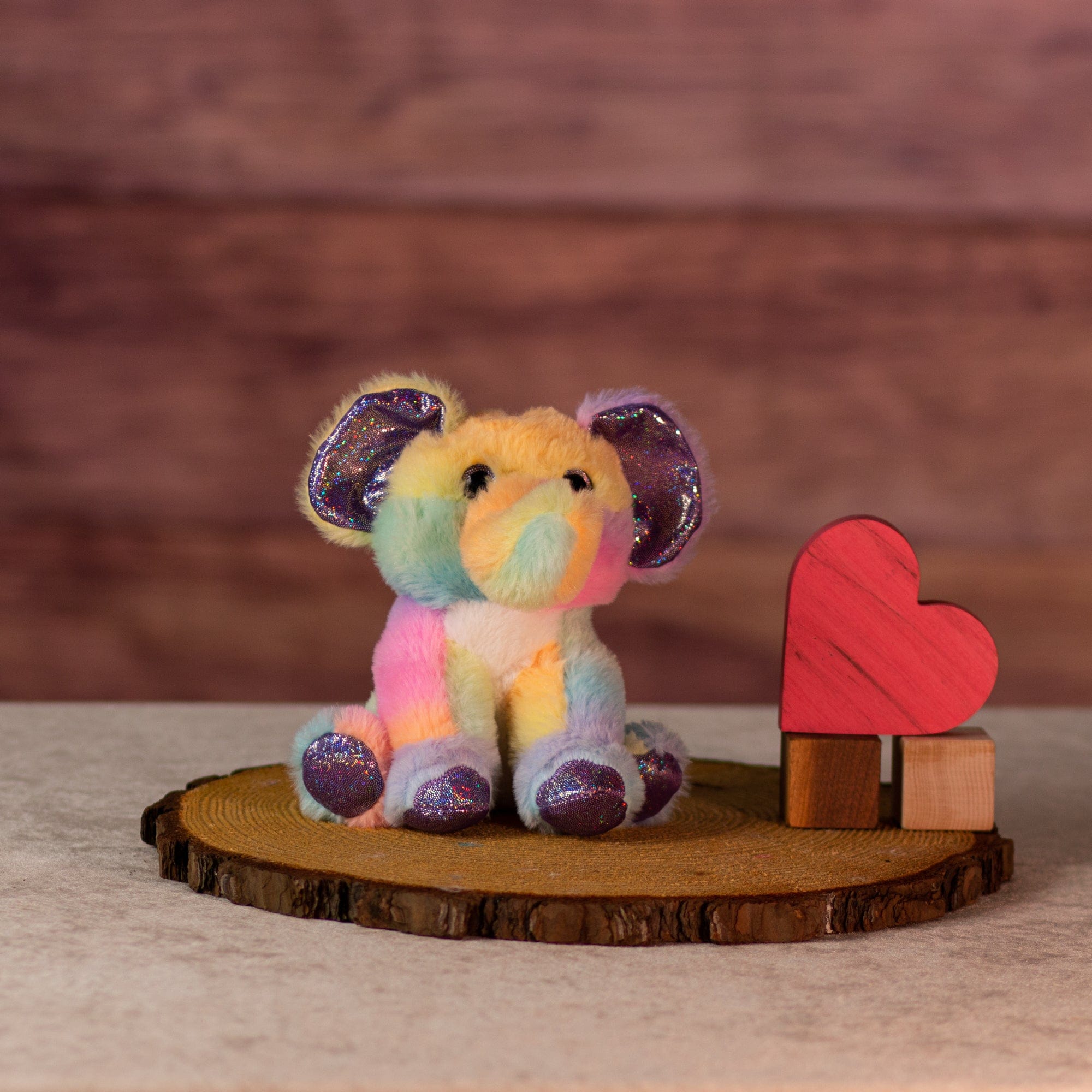 6 in rainbow sherbet elephant with purple glitter hands and feet