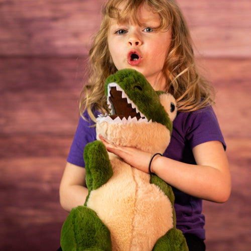 18" stuffed green and tan t-rex with a girl holding it