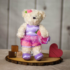 14" stuffed cream ballerina bear wearing a pink and purple leotard and tutu with a pink rose and purple ballet flats