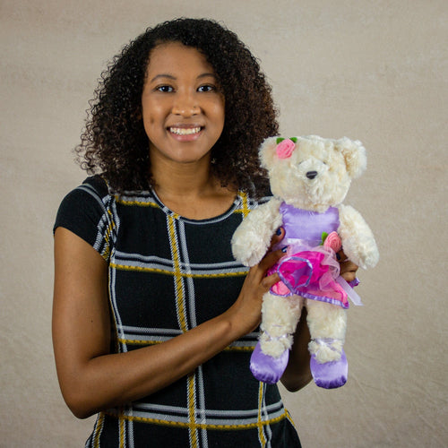 14" stuffed cream ballerina bear wearing a pink and purple leotard and tutu with a pink rose and purple ballet flats