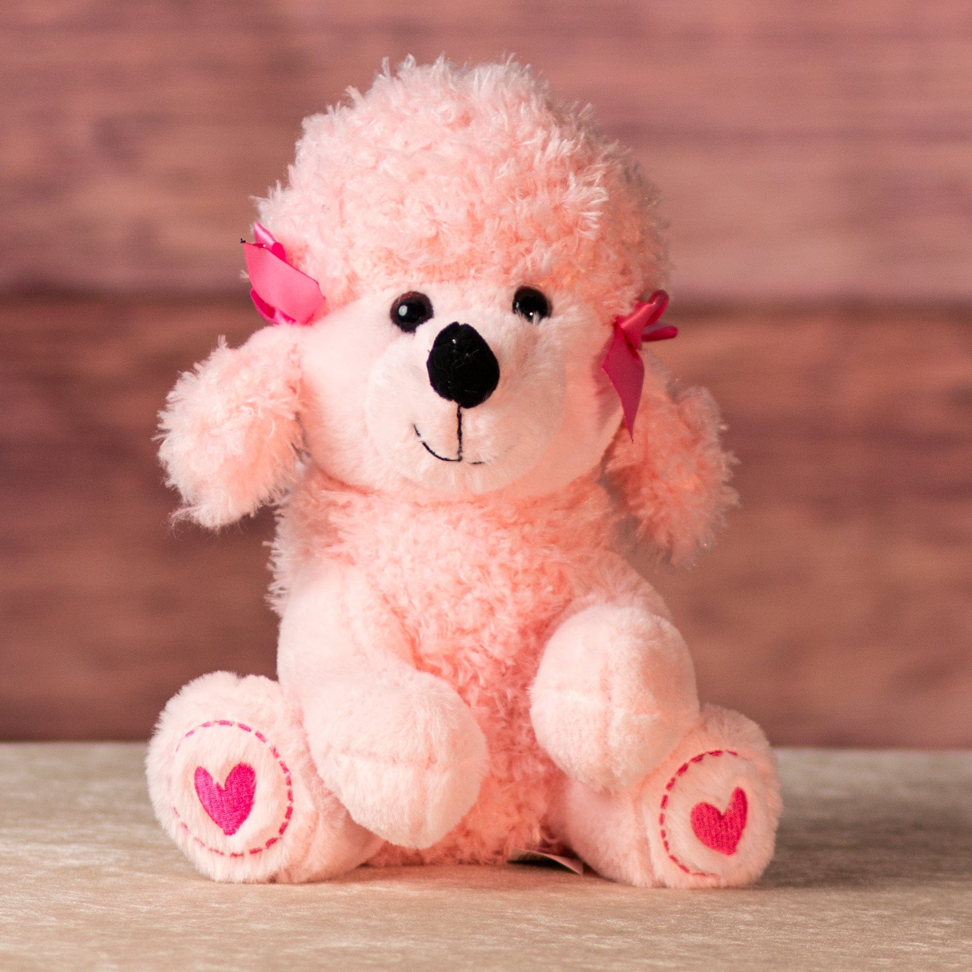 stuffed 10 in pink poodle wearing bows and heart paws