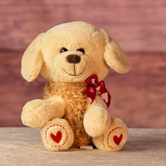 stuffed 10 in brown puppy wearing bows and heart paws