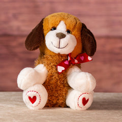 stuffed 10 in brown puppy wearing a heart bow and heart paws