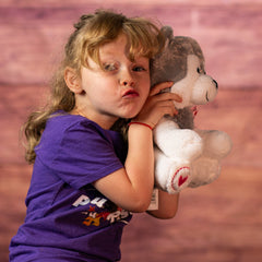 girl holding stuffed husky with a heart paw