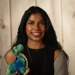 Stuffed brontosaurus with young woman