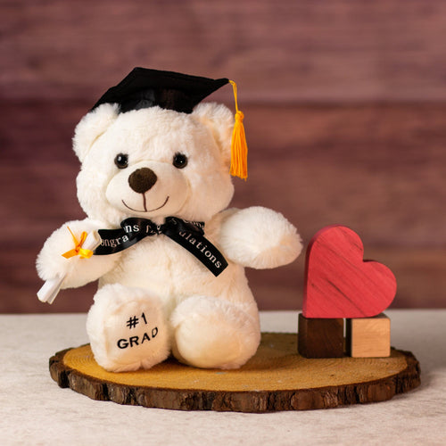 9 in white graduation bear in cap, celebratory bow and diploma