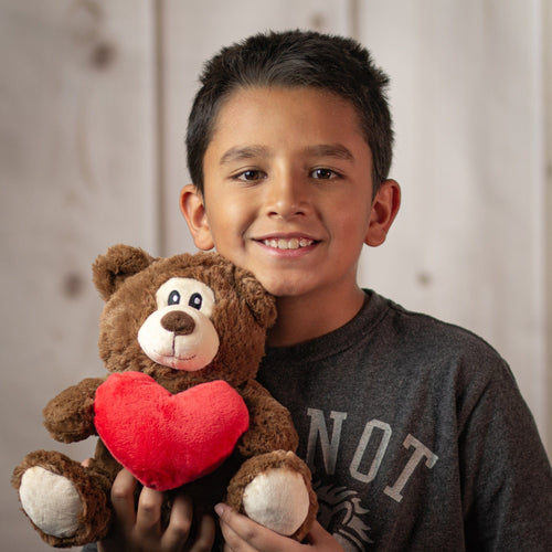 boy holding 9.5" Simple Love Bear Duo in brown holding red heart