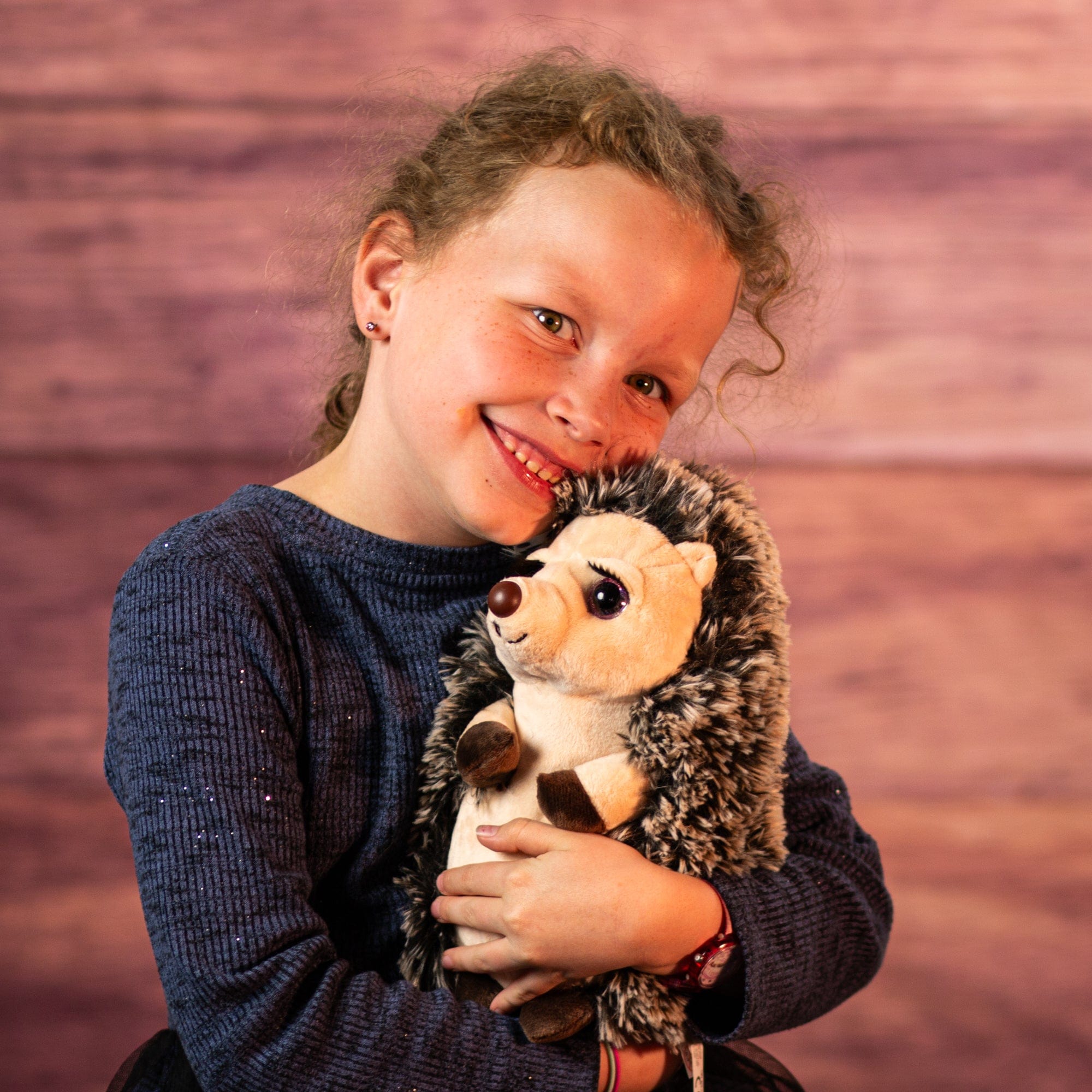 Girl holding hedgehog with eyelashes