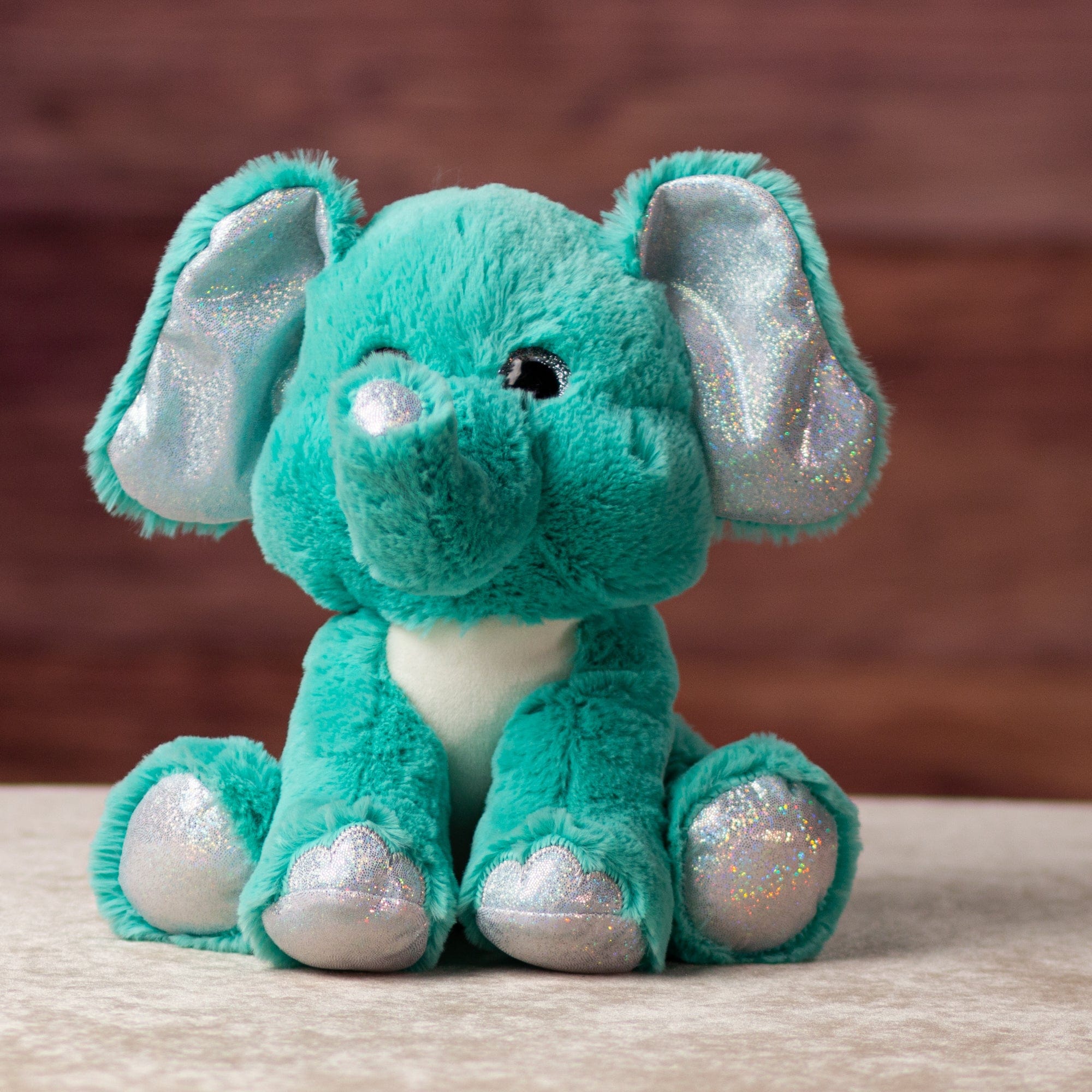 10 in stuffed blue elephant with glitter eyes and glitter ears and paws