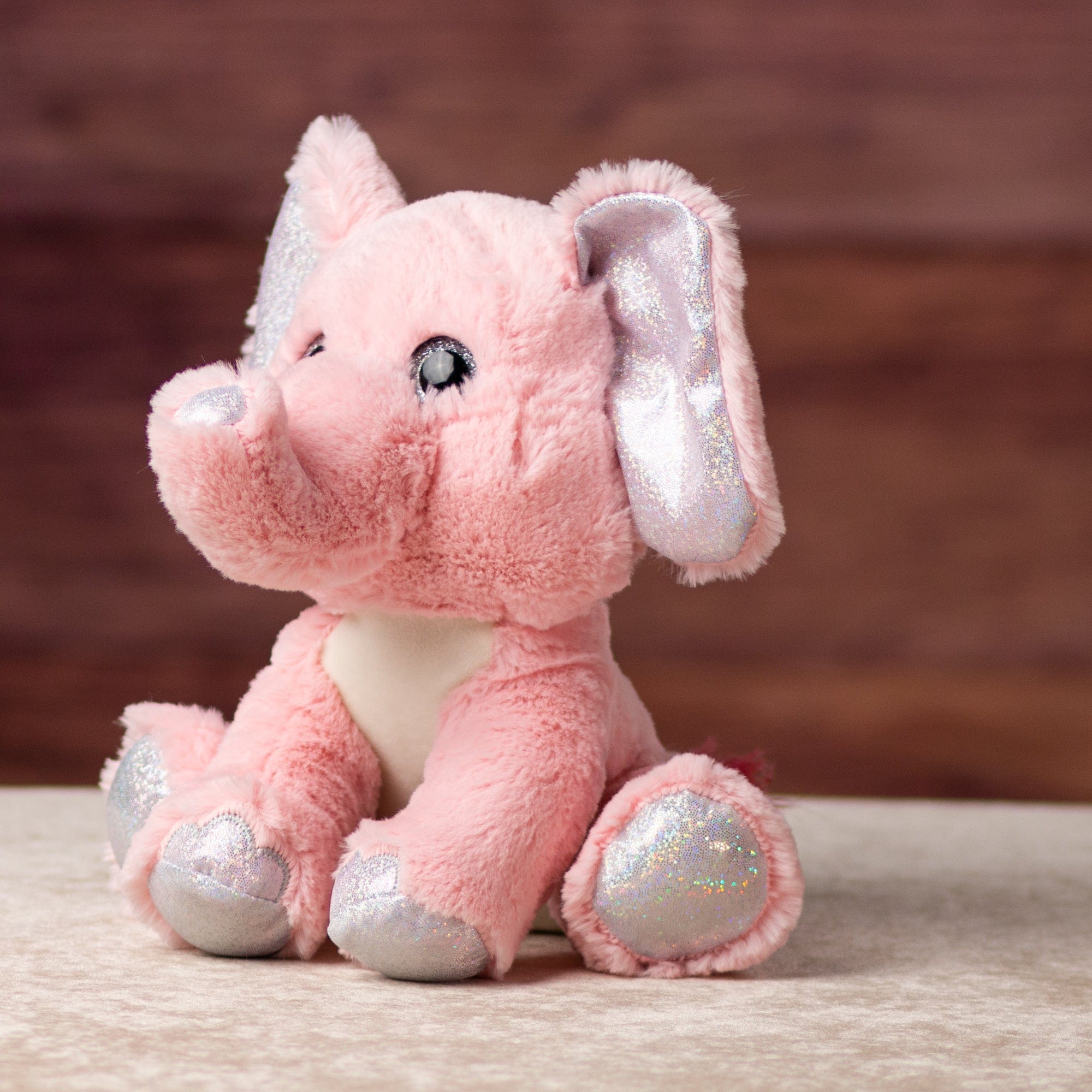 10 in stuffed pink elephant with glitter eyes and glitter ears and paws