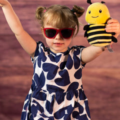 girl holding 6 in stuffed yellow and black bee