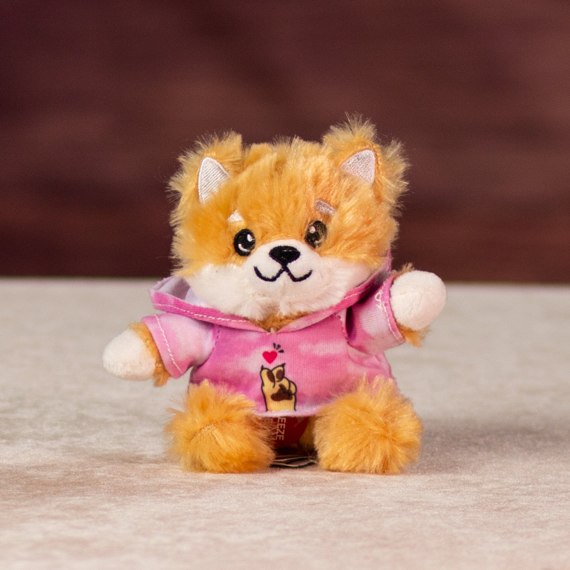 6 in stuffed singing dog in a pink hoodie