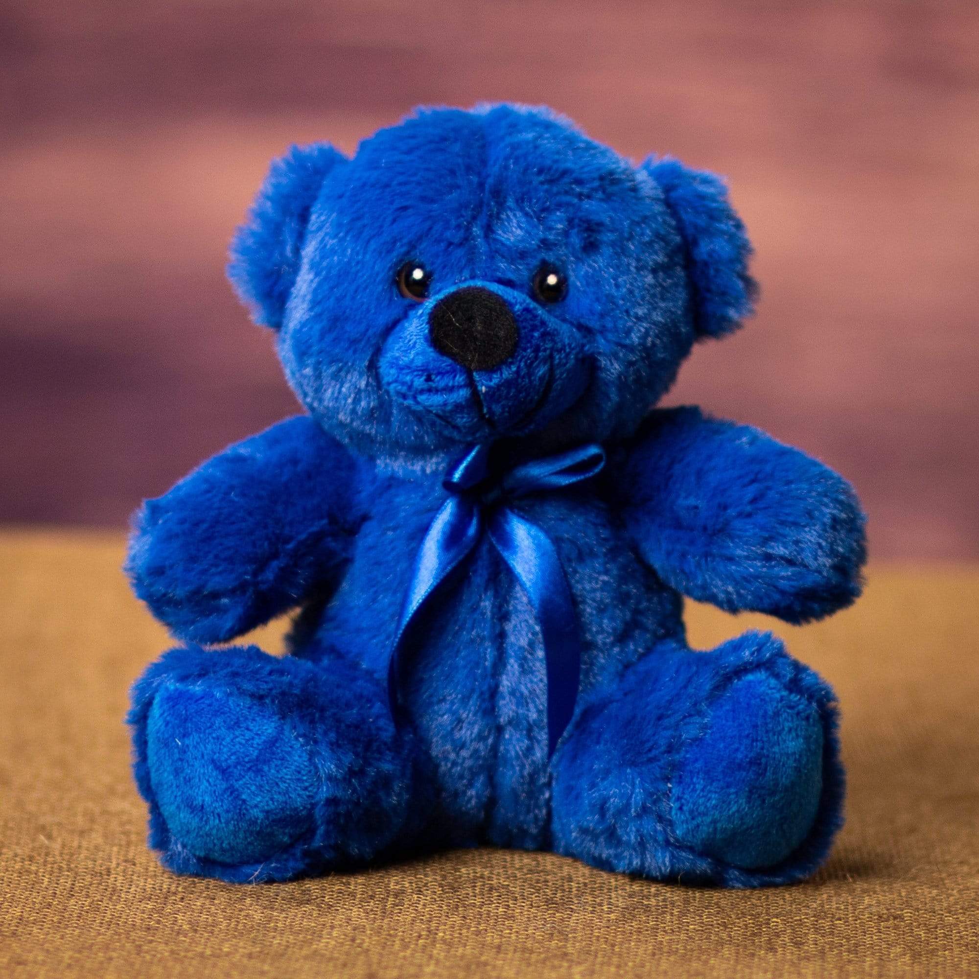 A blue bear that is 6 inches tall while sitting