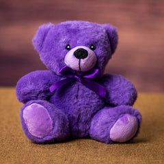 A purple bear that is 6 inches tall while sitting 