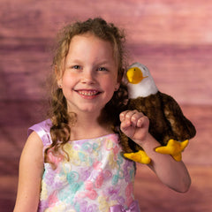 girl holding 9 in stuffed majestic eagle 