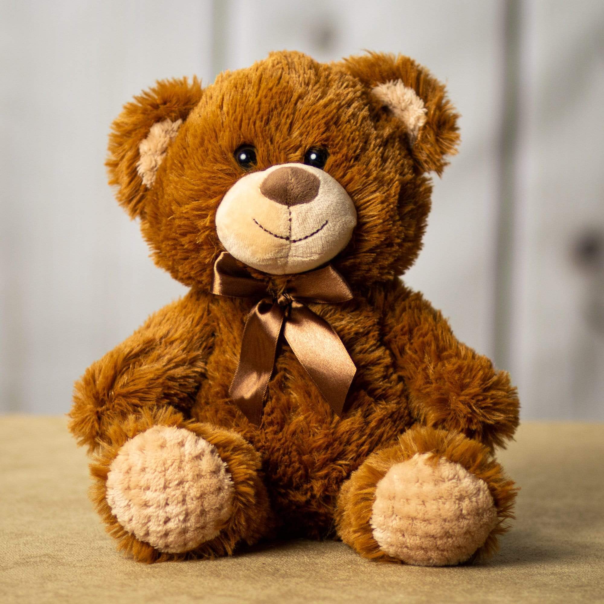 A brown bear that is 10.5 inches tall while sitting