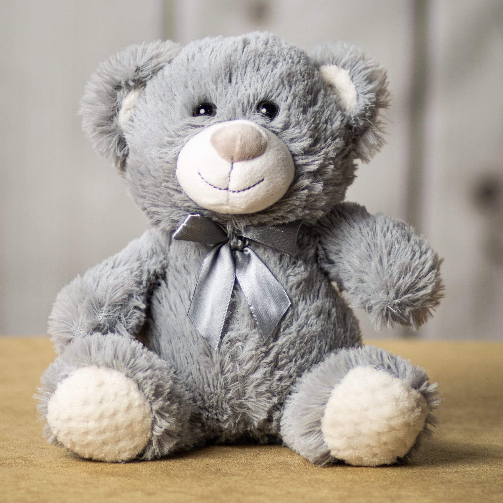 A gray bear that is 10.5 inches tall while sitting