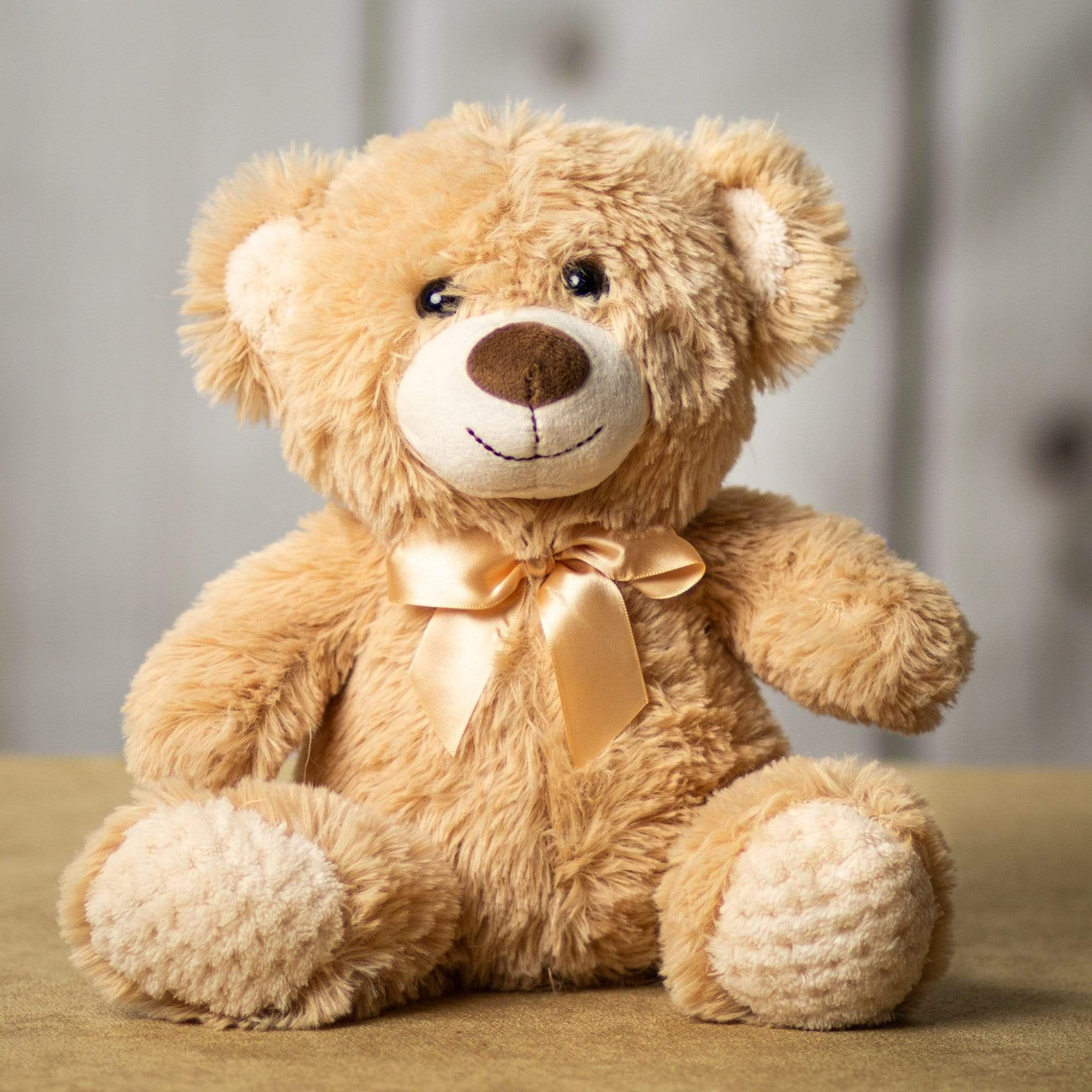 A beige bear that is 10.5 inches tall while sitting