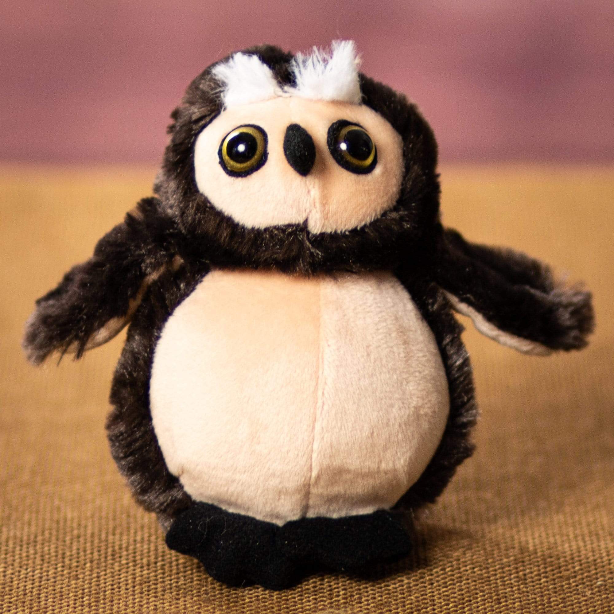 A stuffed owl that is 5 inches tall while sitting 