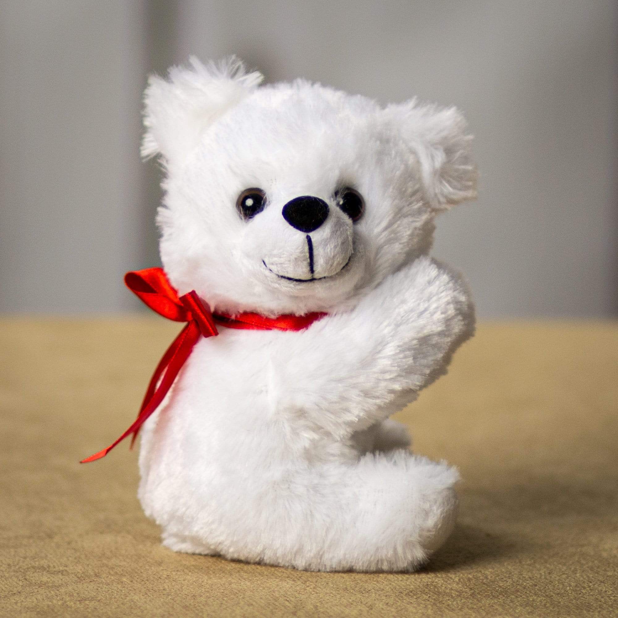 A white bear that is 5.5 inches tall while sitting