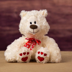 A nice looking cream valentine bear with hearts for paw prints