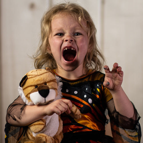 A little girl holding a stripped tiger that is standing 13 inches tall from head to toe