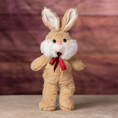 A beige rabbit that is 13 inches while standing wearing a red bow